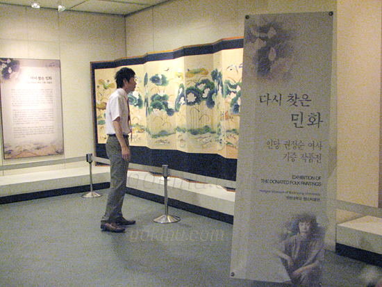 '다시 찾은 민화 - 인당 권정순 여사 기증 작품전'을 관람 중인 지역 주민