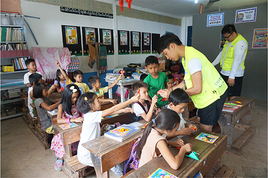 바디앙 초등학교에서 국외봉사 참여학생들이 교육봉사의 일환으로 아이들에게 도움을 주고 있다. 계명카리타스봉사센터